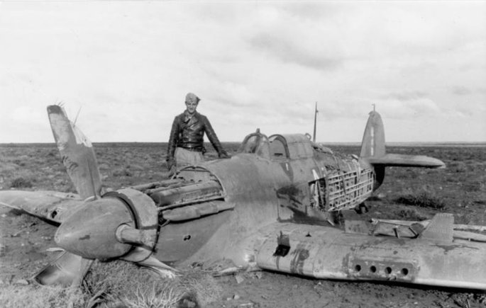 Hans-Joachim Marseille standing next to a downed Hurricane